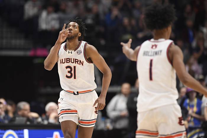 Mar 17, 2024; Nashville, TN, USA; Auburn Tigers guard Chaney Johnson (31) reacts after shooting a three pointer in the first half against the Florida Gators in the SEC Tournament championship game at Bridgestone Arena.
